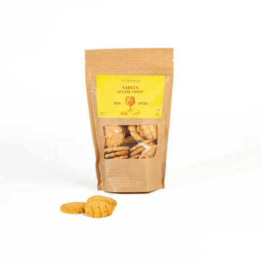 Kraft paper bag with a yellow label containing cookies on a white background