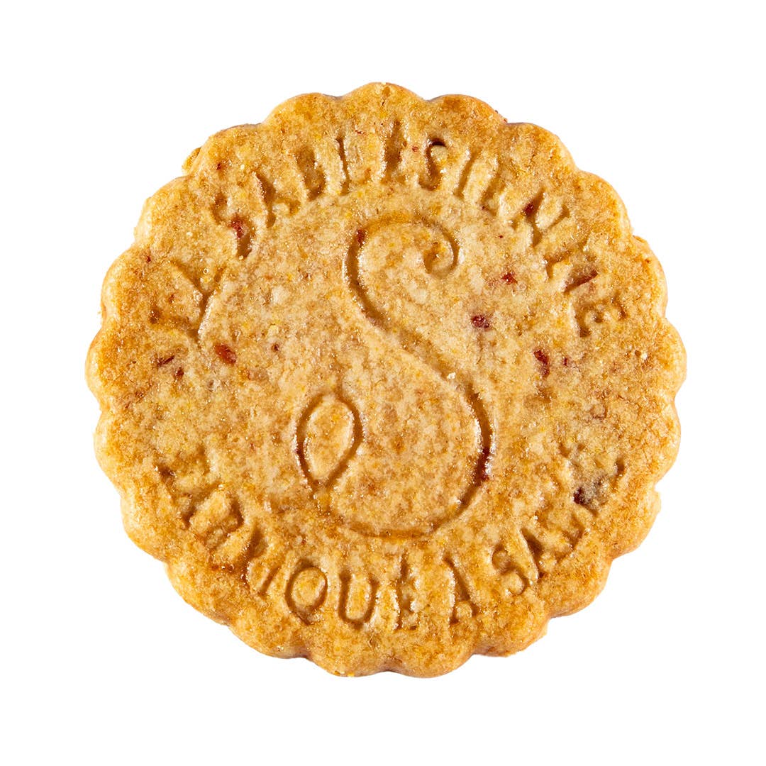 Round cookie with embossed letter 'S' on a white background