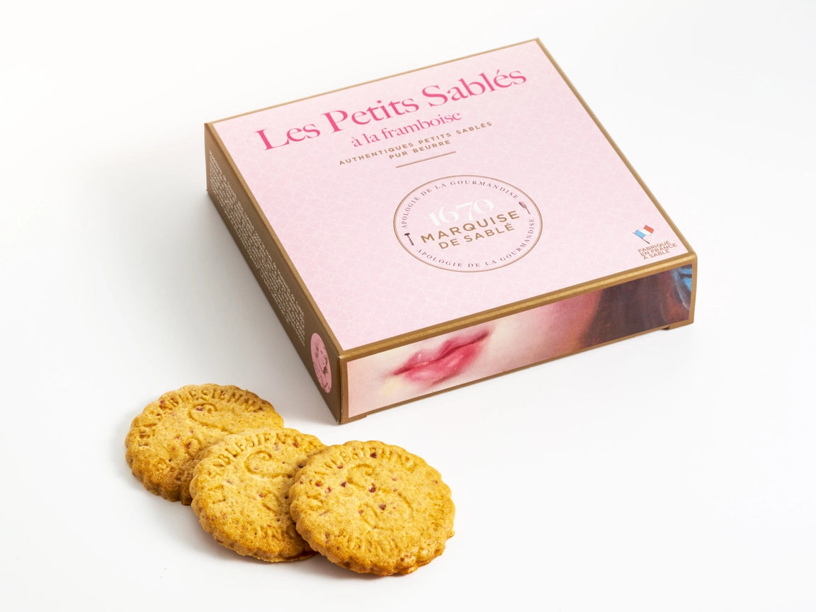 Box of 'Les Petits Sables' cookies with cookies in front on a white background