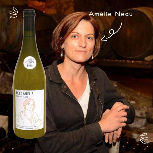 Woman holding a bottle of wine with 'Amélie Neau' branding, set against a wine cellar background.