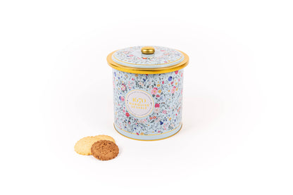 Decorative cookie tin with floral pattern on a white background