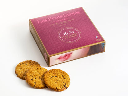 Box of 'Les Petits Sablés' cookies with three cookies in front on a white background