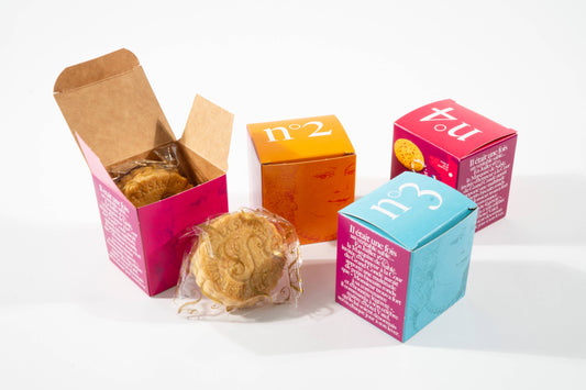 Colorful boxes with cookies on a white background