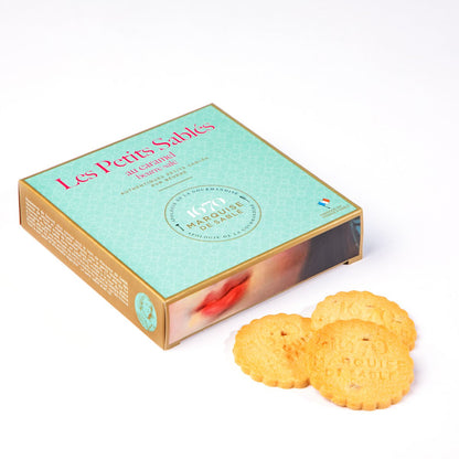 Box of 'Les Petits Sahès' cookies with two cookies on a white background