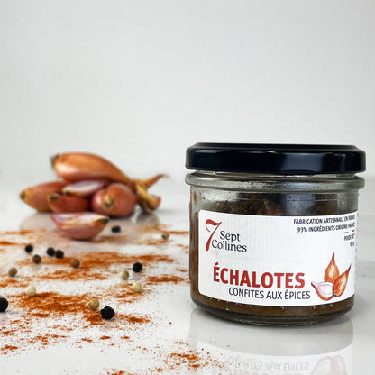 Jar of Échalotes confites aux épices with onions and spices on a white background